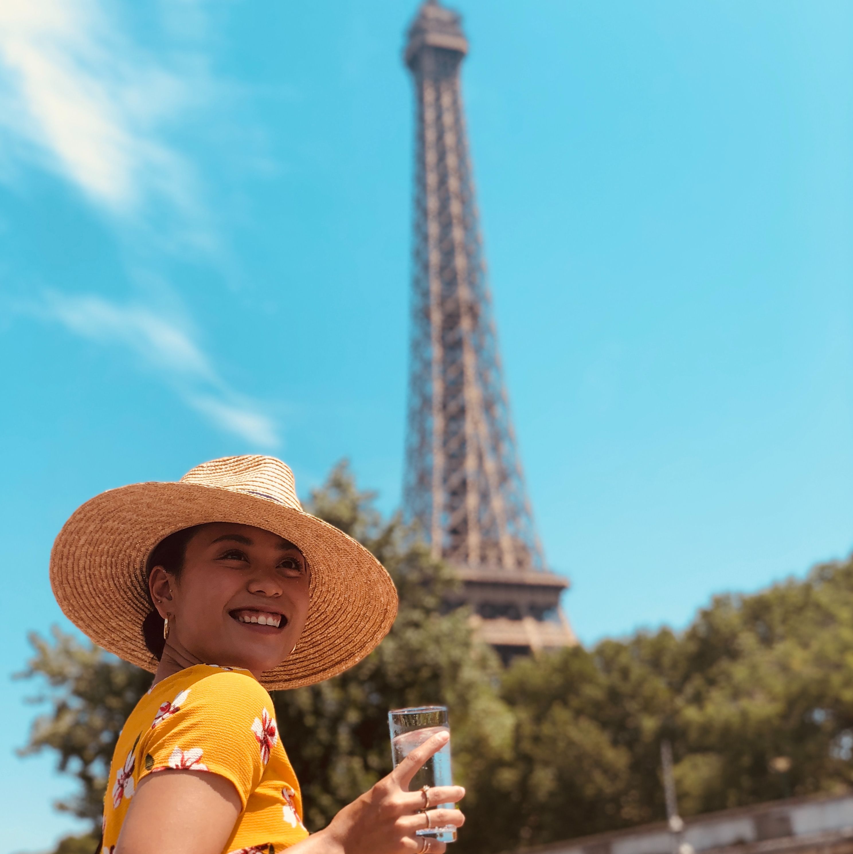 Woman in sunhat by the Eiffel Tower